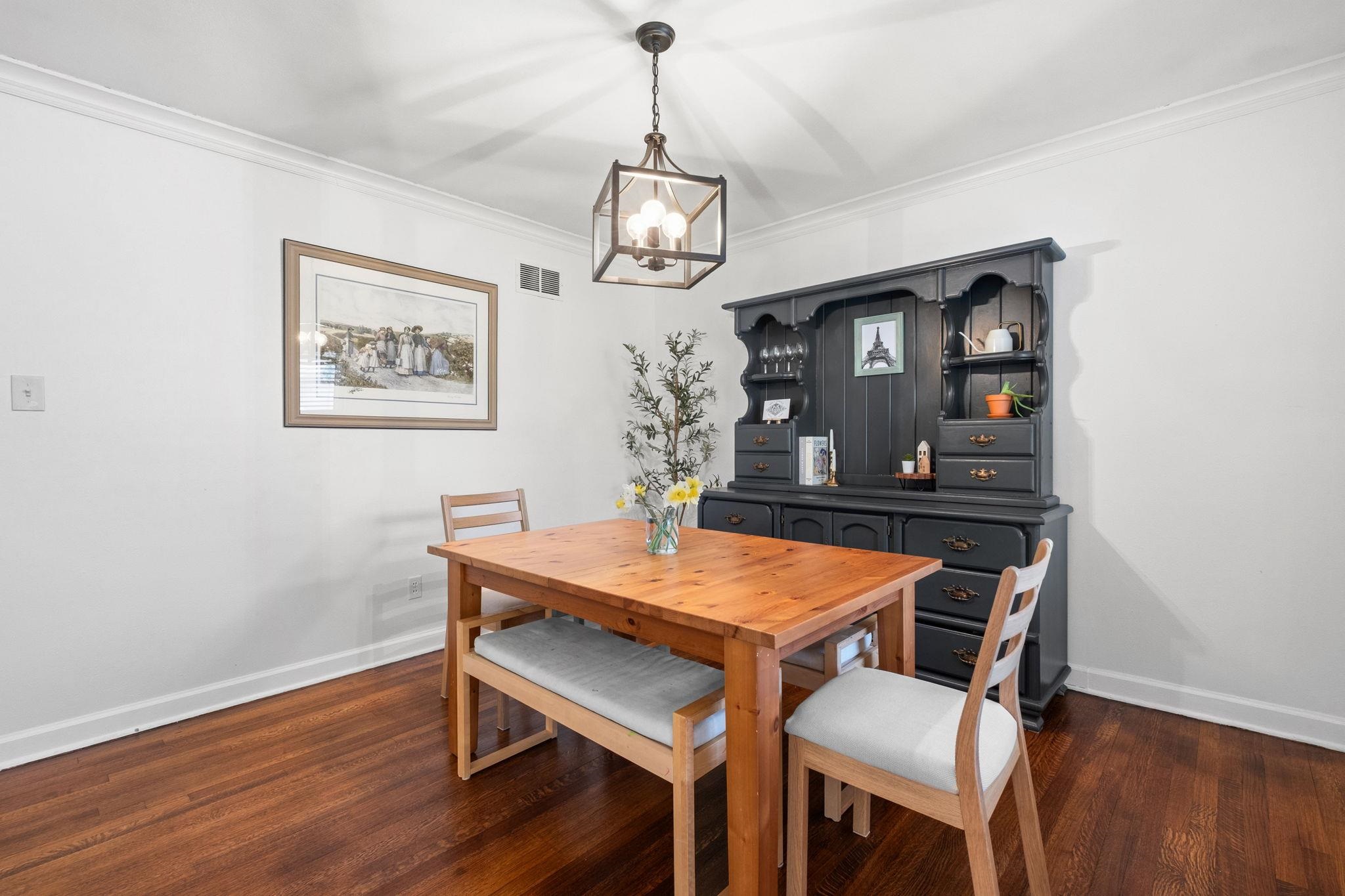 1207 West Perkins Road Memphis, TN 38117 - Photo 9 of 40 Dining area with ornamental molding, dark wood finished floors, and a chandelier