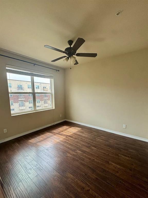 1100 West Trinity Mills Road, Unit 3010 Carrollton, TX 75006 - Photo 2 of 10 a view of an empty room with wooden floor and a window