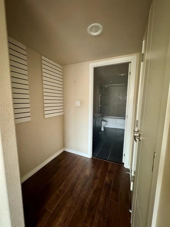 1100 West Trinity Mills Road, Unit 3010 Carrollton, TX 75006 - Photo 4 of 10 a view of a room with wooden floor and a bathroom