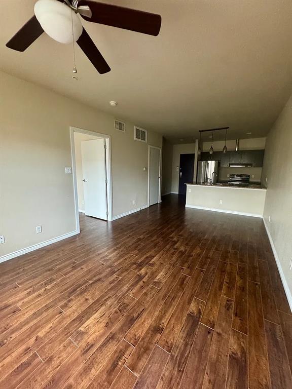 1100 West Trinity Mills Road, Unit 3010 Carrollton, TX 75006 - Photo 8 of 10 a view of empty room with wooden floor