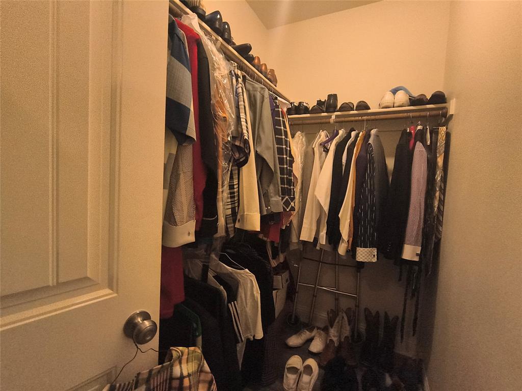 3027 Ames Road Lancaster, TX 75134 - Photo 19 of 35 Walk-in closet featuring extensive shelving and multiple clothing rods