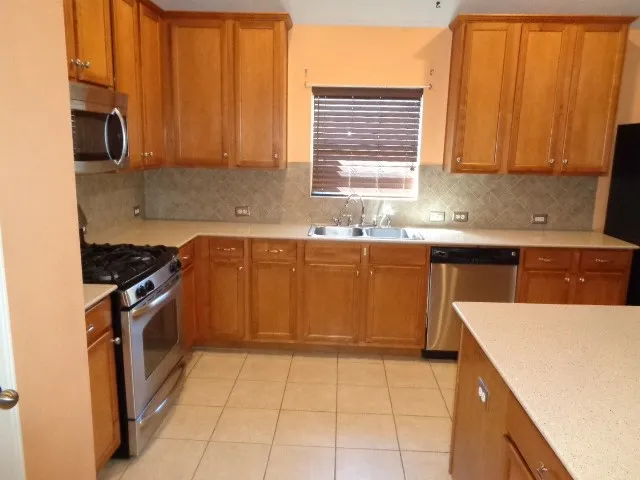 a kitchen with a sink stove top oven and cabinets