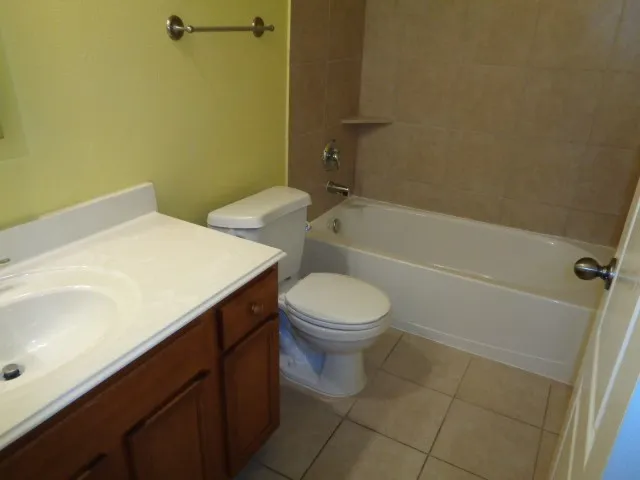 a bathroom with a sink a toilet and bathtub