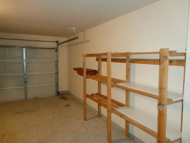 a view of an empty room with a cabinet