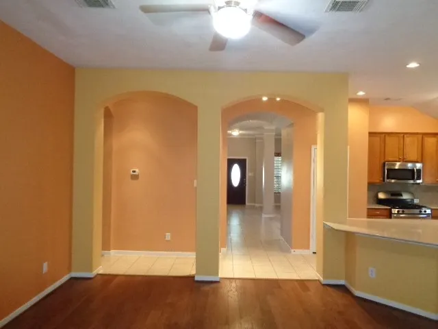 a view of a hallway with wooden floor