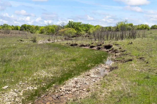 a view of a lake with a yard