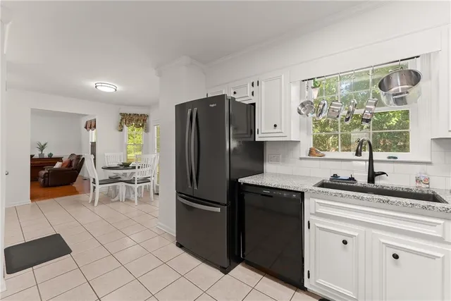 a kitchen with a sink cabinets and stainless steel appliances