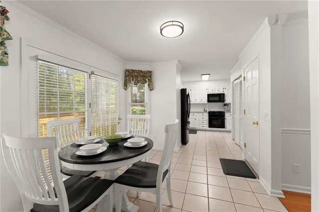 a view of a dining room with furniture and a large window