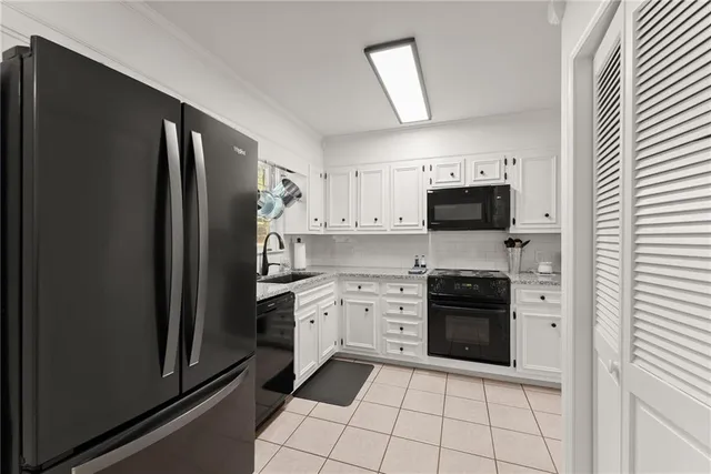 a kitchen with stainless steel appliances granite countertop a refrigerator stove and sink