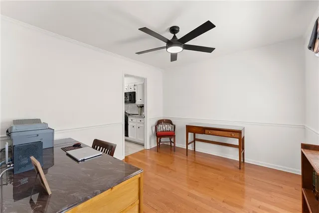 a view of a workspace with furniture and wooden floor