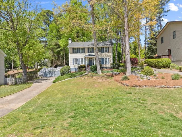 a view of a house with a yard patio and fire pit
