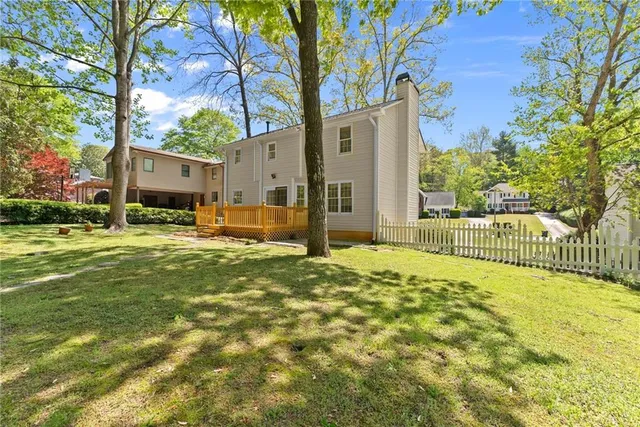 a yellow house with trees in front of it