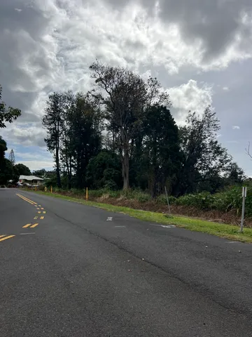 a view of a street with trees in the background