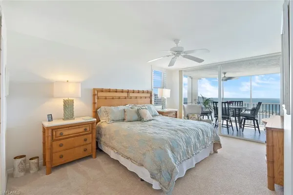 a bedroom with a bed a table and chairs