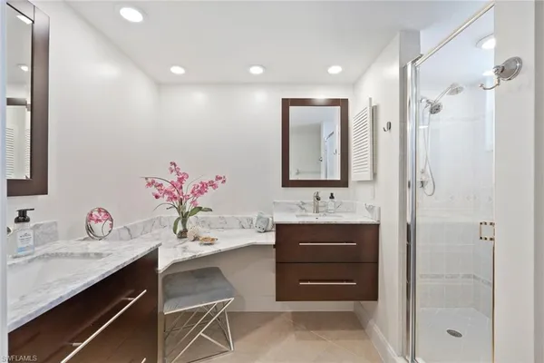 a bathroom with a sink vanity tub and shower