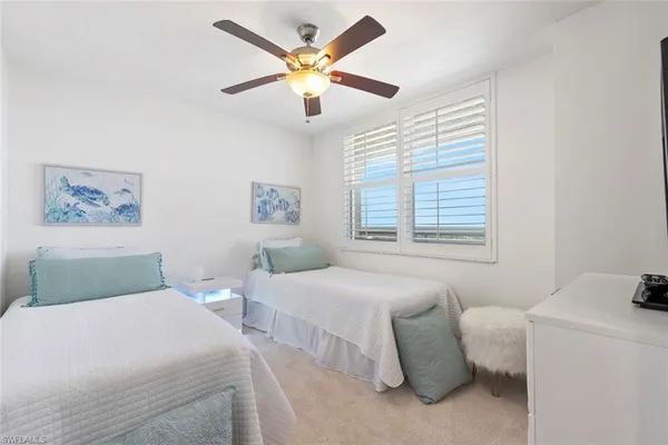 a bedroom with two beds and a window