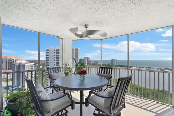 a outdoor dining space with furniture and city view