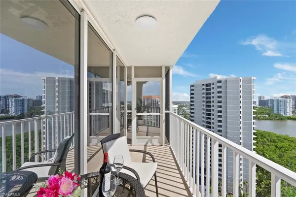 a balcony with wooden floor and city view