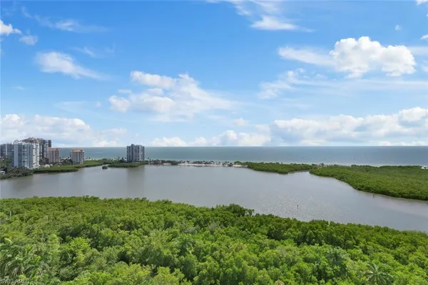 a view of a lake with houses in the back