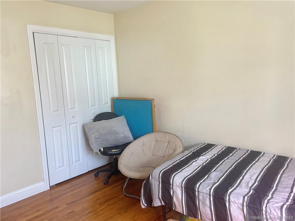 55 Oak Ridge Drive, Unit 60 New Haven, CT 06513 - Photo 14 of 16 a bedroom with a bed and wooden floor