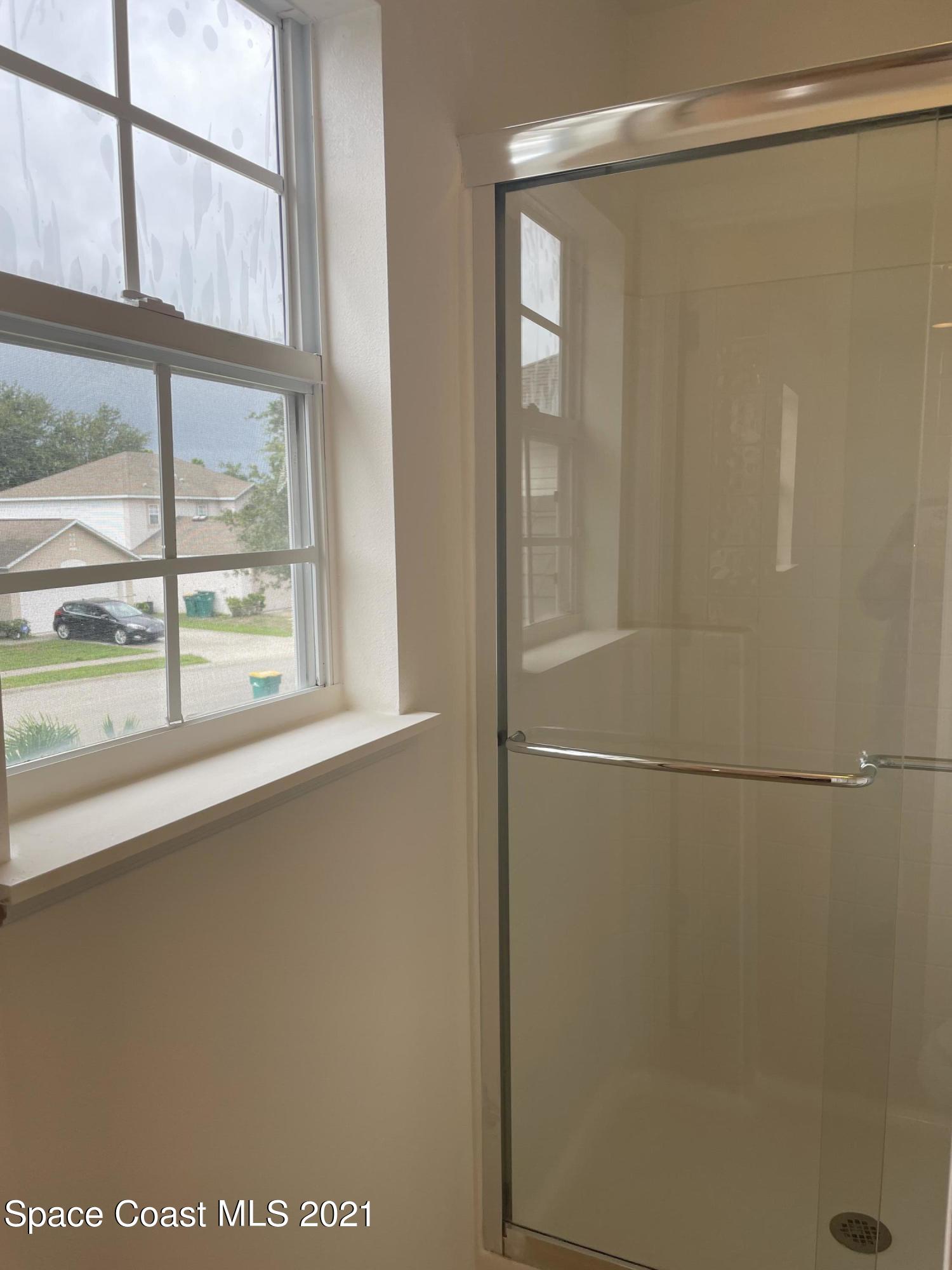 2315 Canopy Drive Melbourne, FL 32935 - Photo 13 of 27 a view of a glass door and shower
