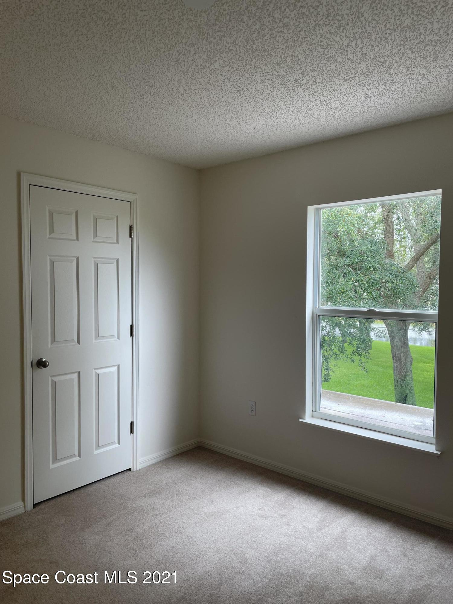 2315 Canopy Drive Melbourne, FL 32935 - Photo 17 of 27 an empty room with a window