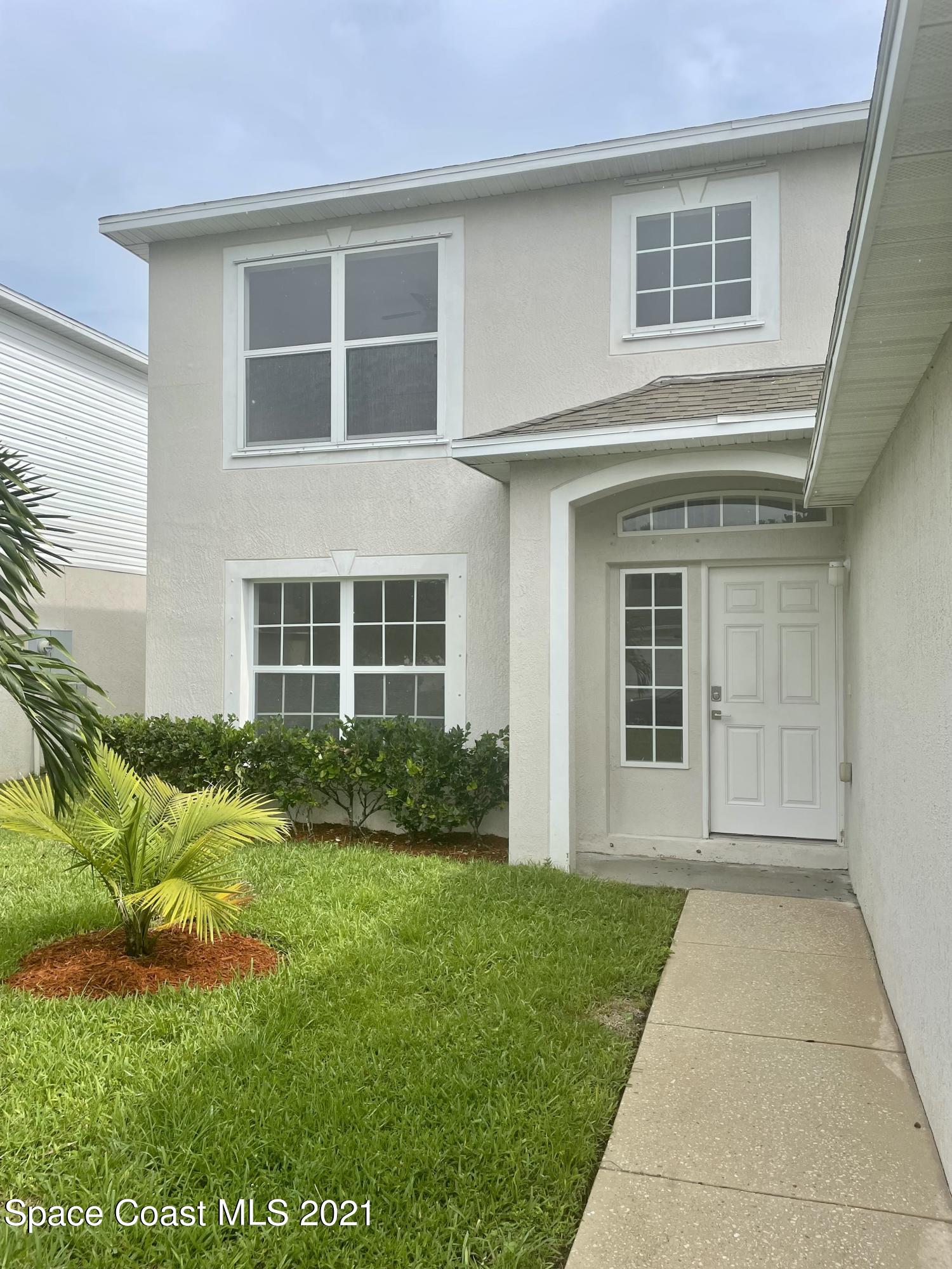 2315 Canopy Drive Melbourne, FL 32935 - Photo 3 of 27 a front view of a house with a yard