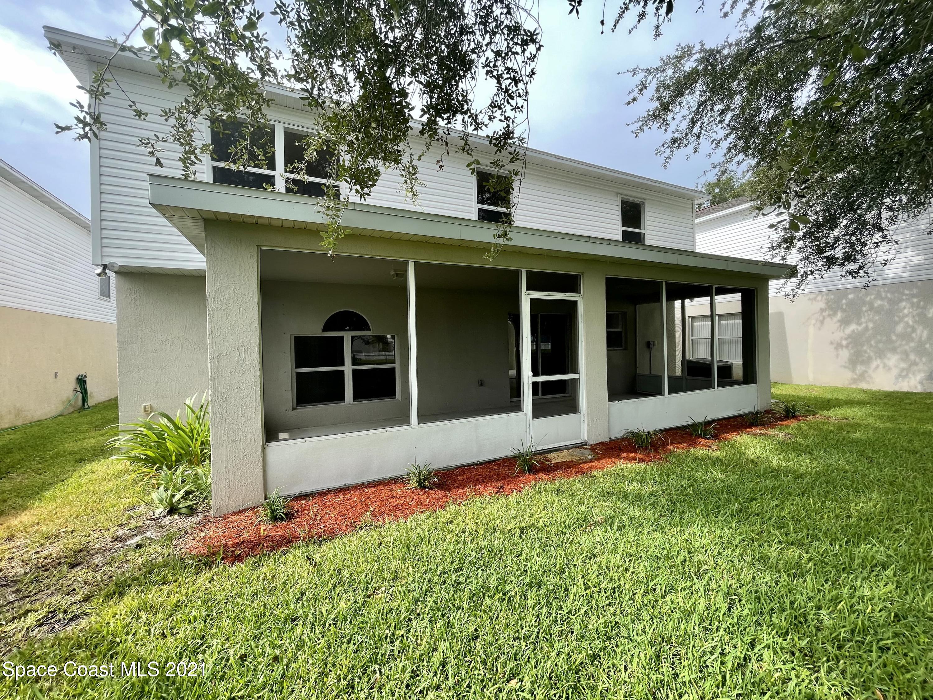 2315 Canopy Drive Melbourne, FL 32935 - Photo 23 of 27 a view of a house with yard and garden