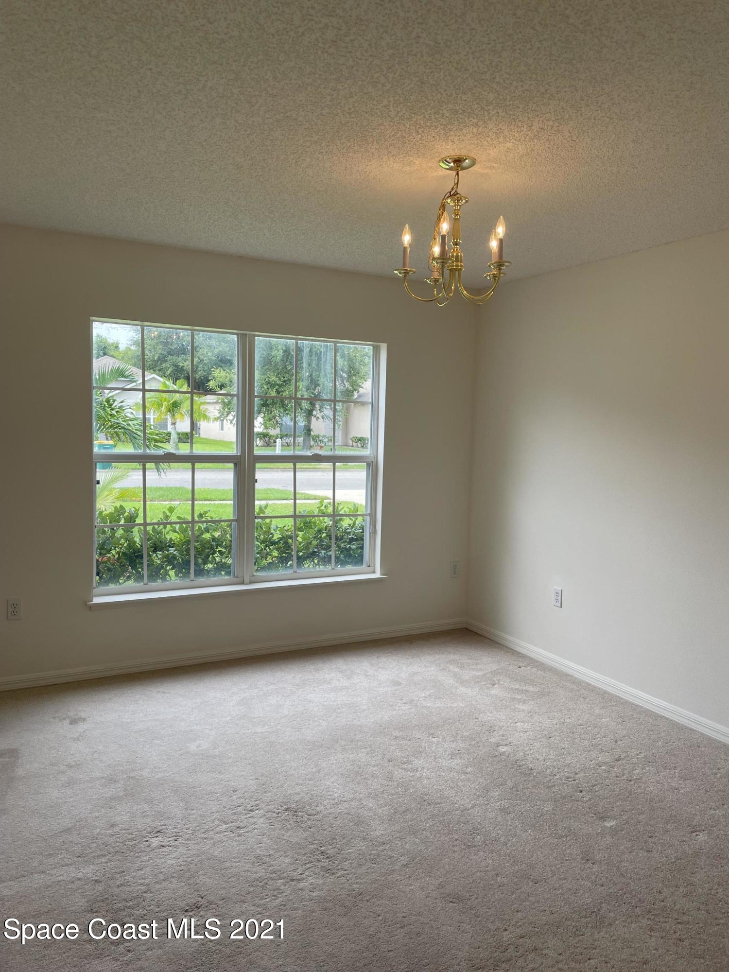 2315 Canopy Drive Melbourne, FL 32935 - Photo 4 of 27 an empty room with a window