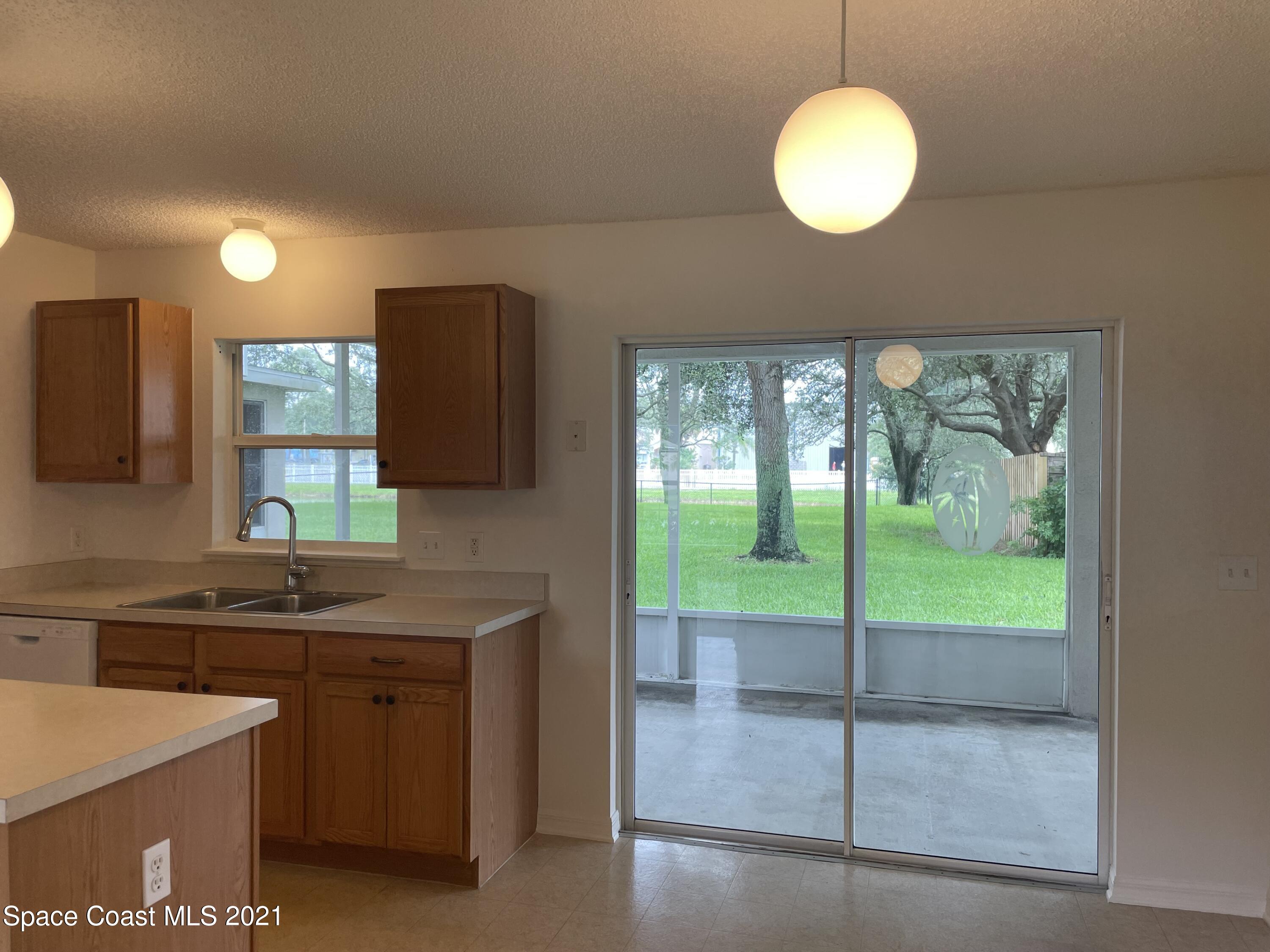 2315 Canopy Drive Melbourne, FL 32935 - Photo 6 of 27 a kitchen with a sink a counter top space cabinets and stainless steel appliances