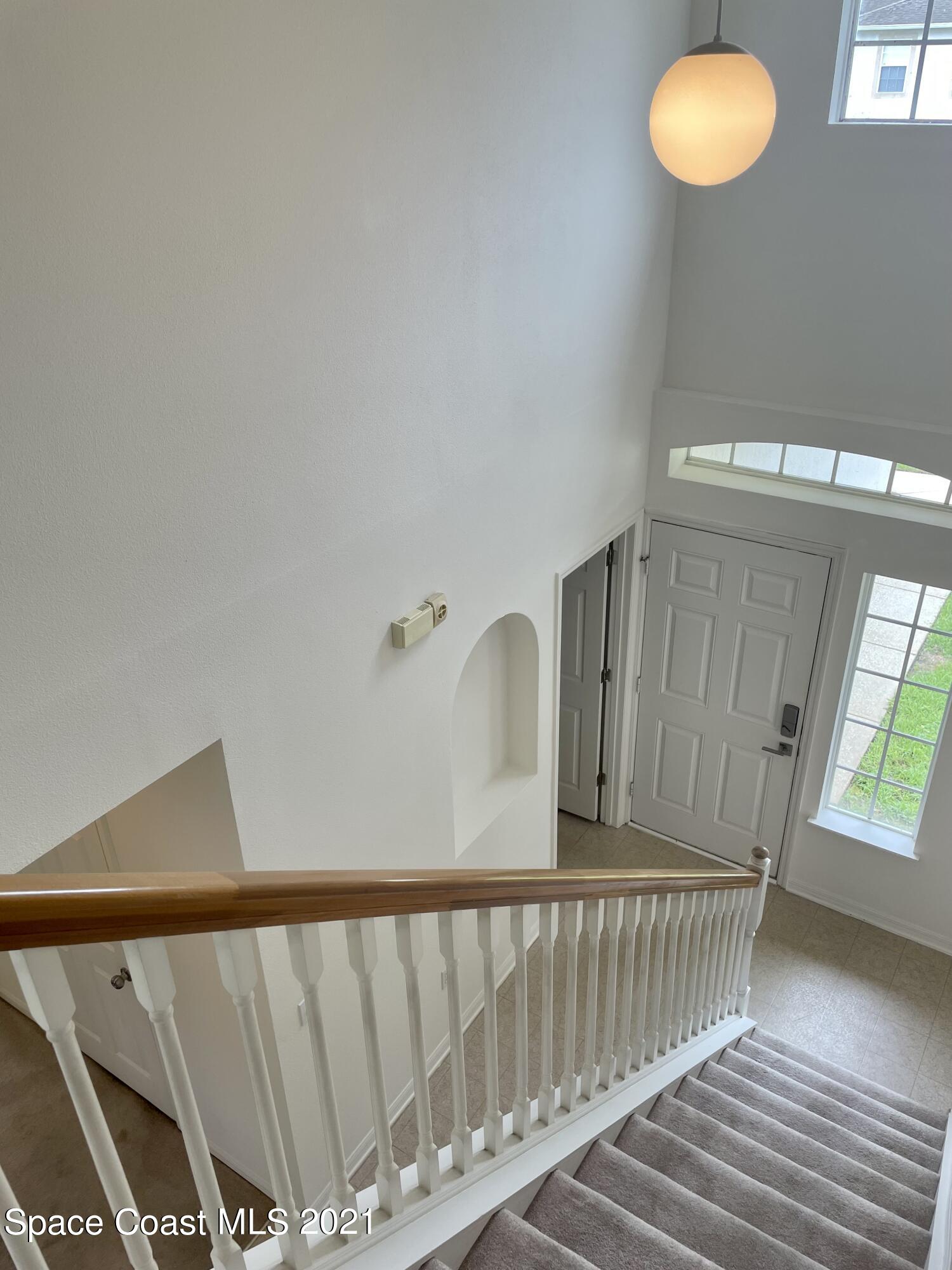 2315 Canopy Drive Melbourne, FL 32935 - Photo 9 of 27 a view of staircase with black carpet