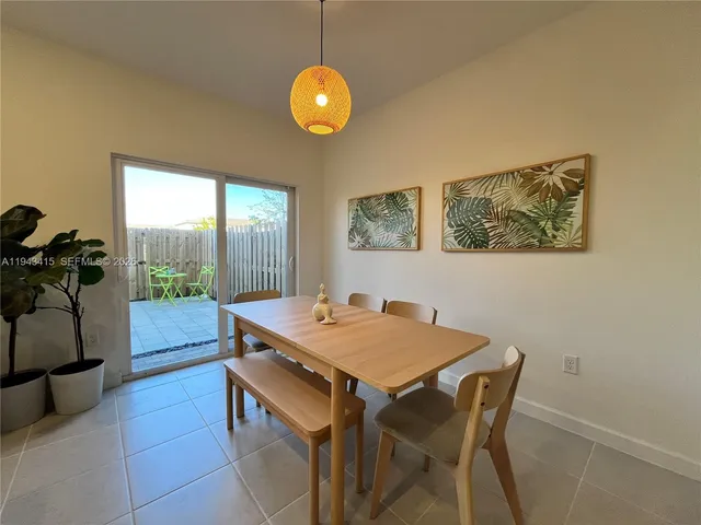 a dining room with a table and chairs