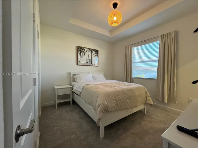 a spacious bedroom with a bed and a table in it