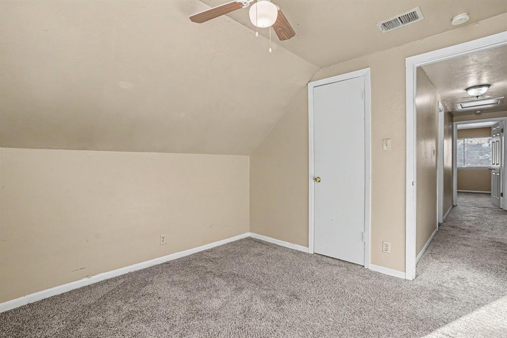 1414 Finley Road Irving, TX 75062 - Photo 22 of 27 Sloped ceiling design, recessed lighting, ceiling fan with light fixture, wall-to-wall carpeting, interior door with brass-finish hardware