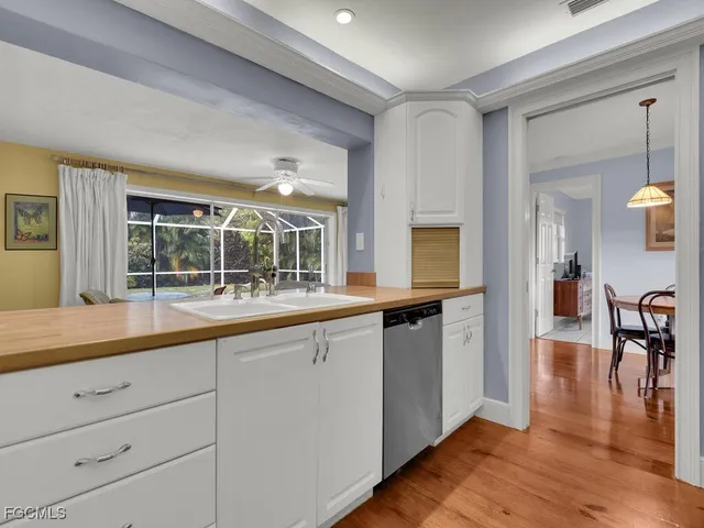 a large living room with stainless steel appliances granite countertop a stove and a wooden floors