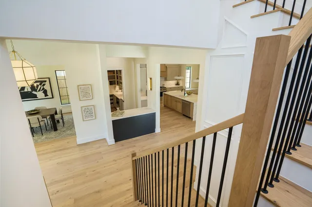 a view of a hallway with wooden floor and furniture