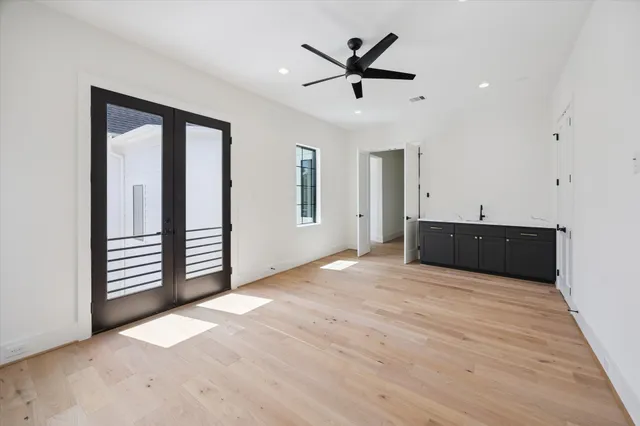 an empty room with cabinet and ceiling fan