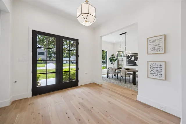 a view of an empty room with window wooden floor
