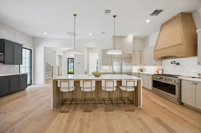a large kitchen with a table and chairs