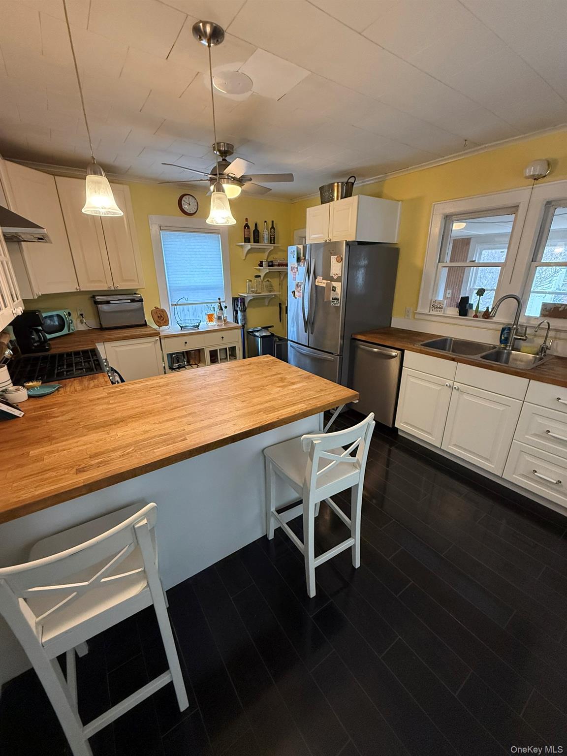 22 Church Street Beacon, NY 12508 - Photo 11 of 25 a kitchen with a table chairs and refrigerator