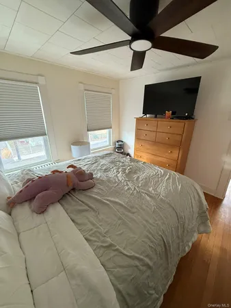 a view of an empty room with furniture and staircase