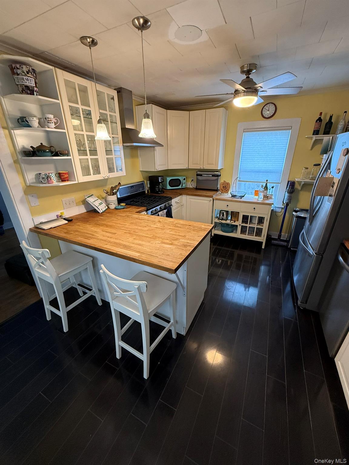 22 Church Street Beacon, NY 12508 - Photo 9 of 25 a kitchen with stainless steel appliances granite countertop a stove a sink dishwasher and cabinets with wooden floor