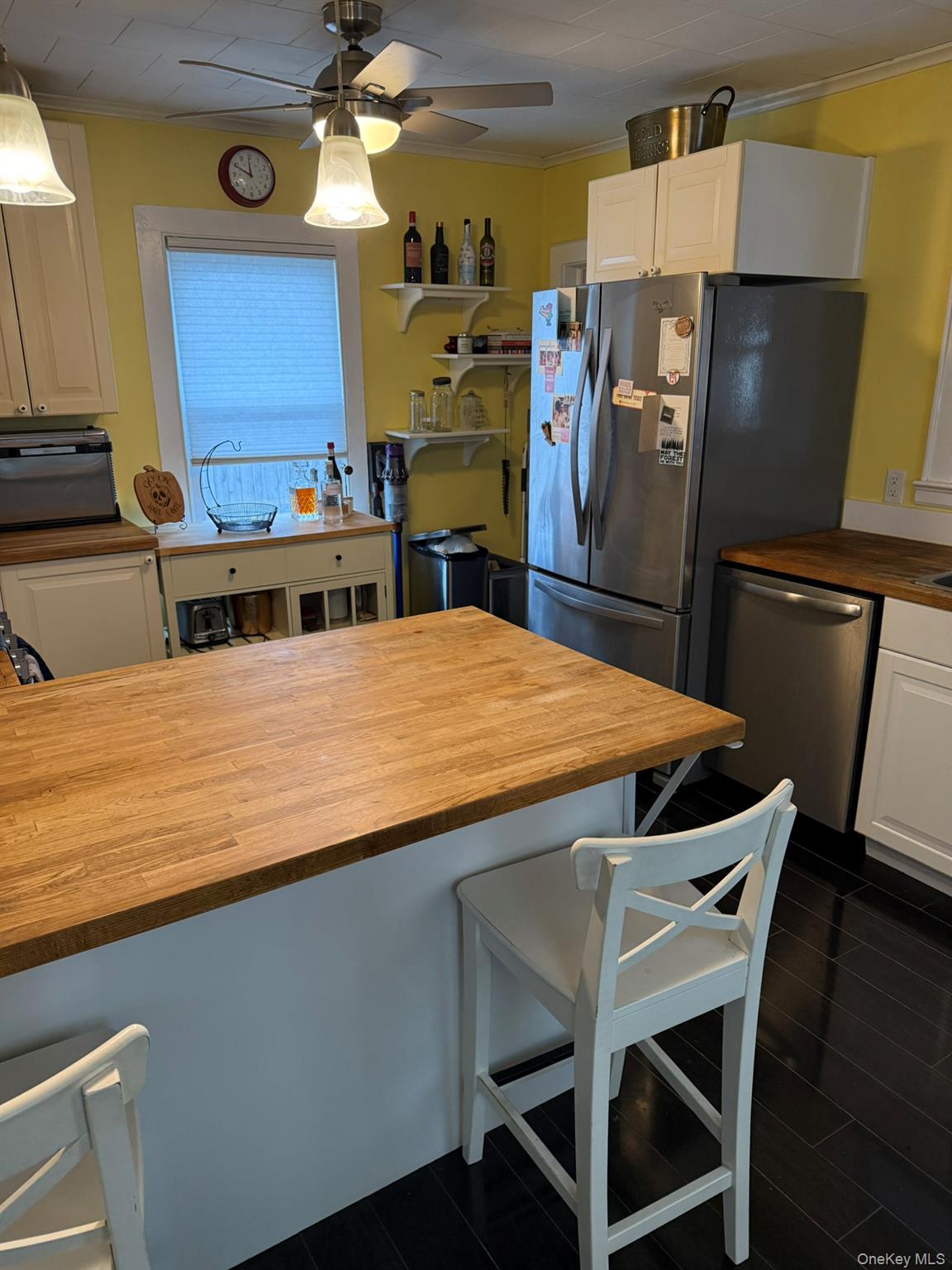22 Church Street Beacon, NY 12508 - Photo 10 of 25 a kitchen with stainless steel appliances kitchen island a table chairs in it and wooden floors