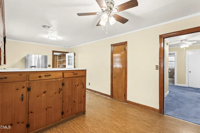 a view of a hallway with wooden floor and cabinet with a sink