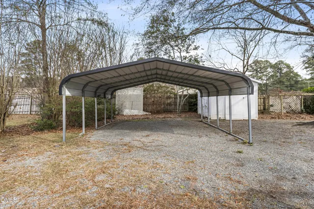 a view of a wooden house with a yard