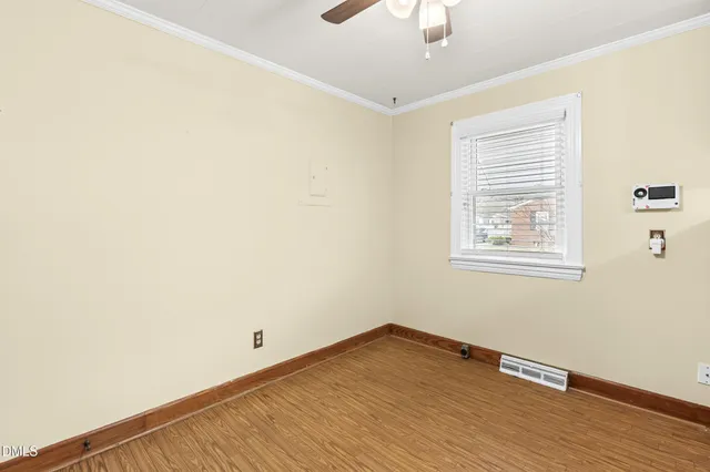 a view of a room with wooden floor and windows