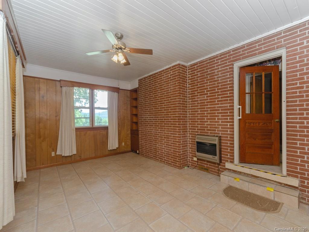 124 Trantham Road Canton, NC 28716 - Photo 14 of 18 a view of an empty room with a fireplace and a window