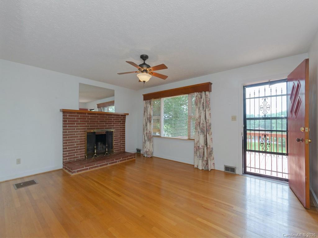 124 Trantham Road Canton, NC 28716 - Photo 3 of 18 wooden floor fireplace and windows in an empty room
