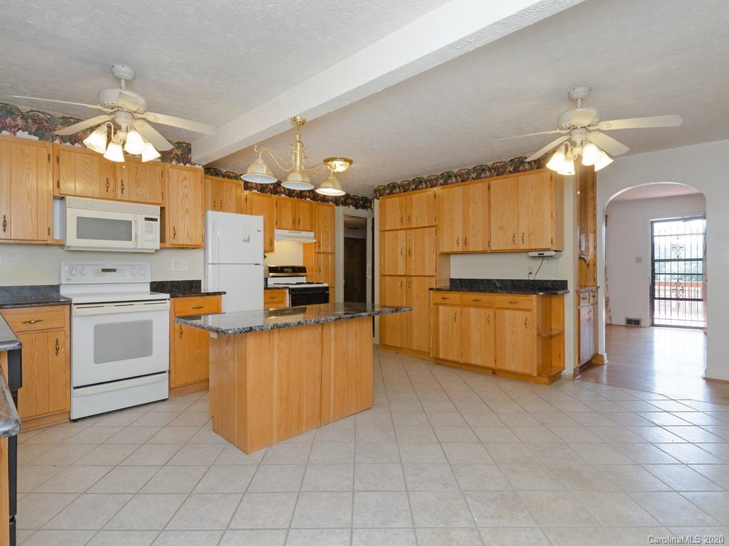 124 Trantham Road Canton, NC 28716 - Photo 4 of 18 a kitchen with cabinets and wooden floor