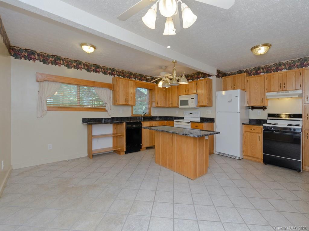 124 Trantham Road Canton, NC 28716 - Photo 5 of 18 a kitchen with stainless steel appliances granite countertop a stove top oven a sink dishwasher and a refrigerator